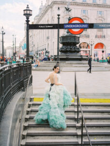 A gorgeous model showcases a stunning ombré dress with ruffled layers in green hues